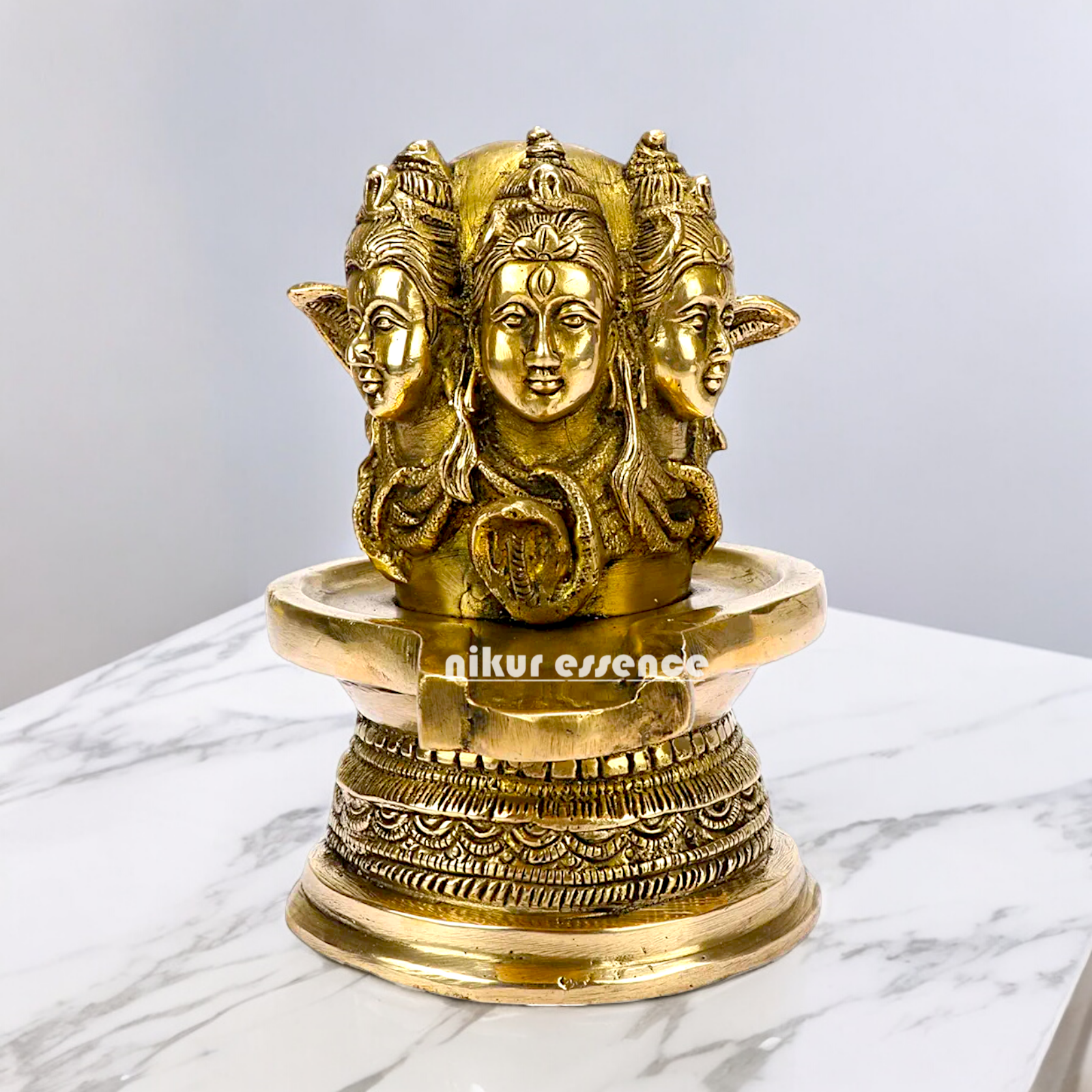 Solid Brass Shivling with Three Face Shiva idol on Shivling Idol - 16 cm Nikuressence
