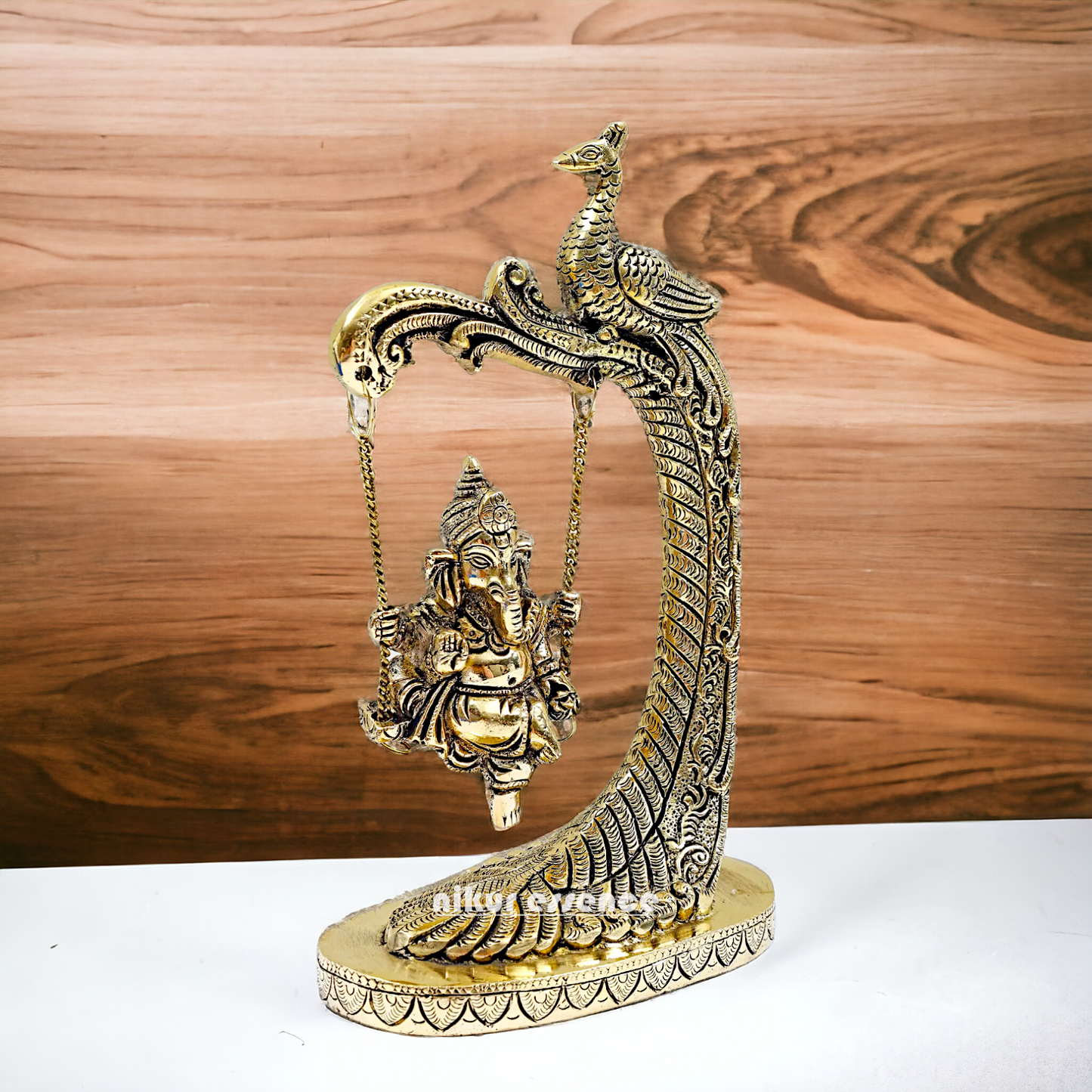 Lord Ganpati swinging Jhula Brass idol - 9 Inches Nikuressence