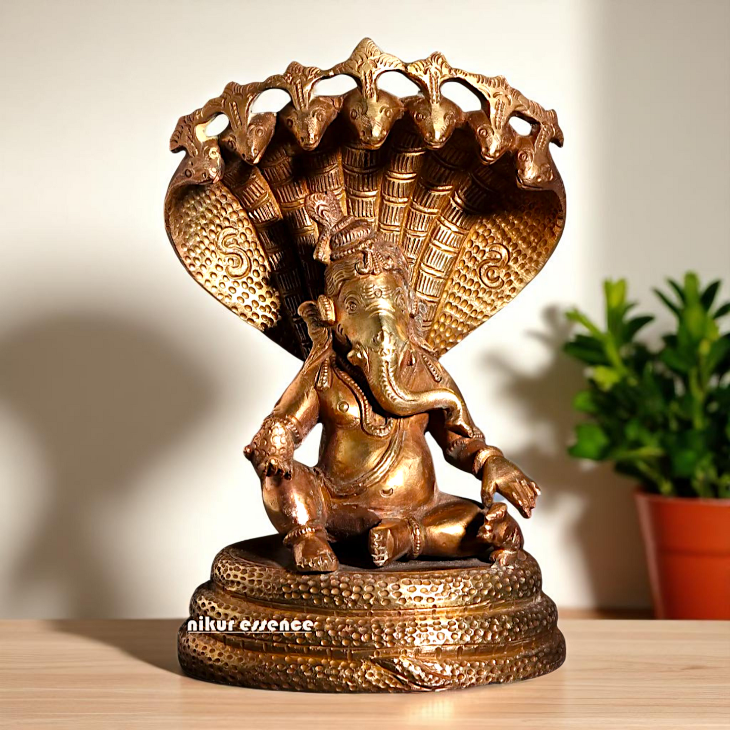 Bronze/Panchaloha Ganesha seated on sheshnag statue - 7 Inches Nikuressence