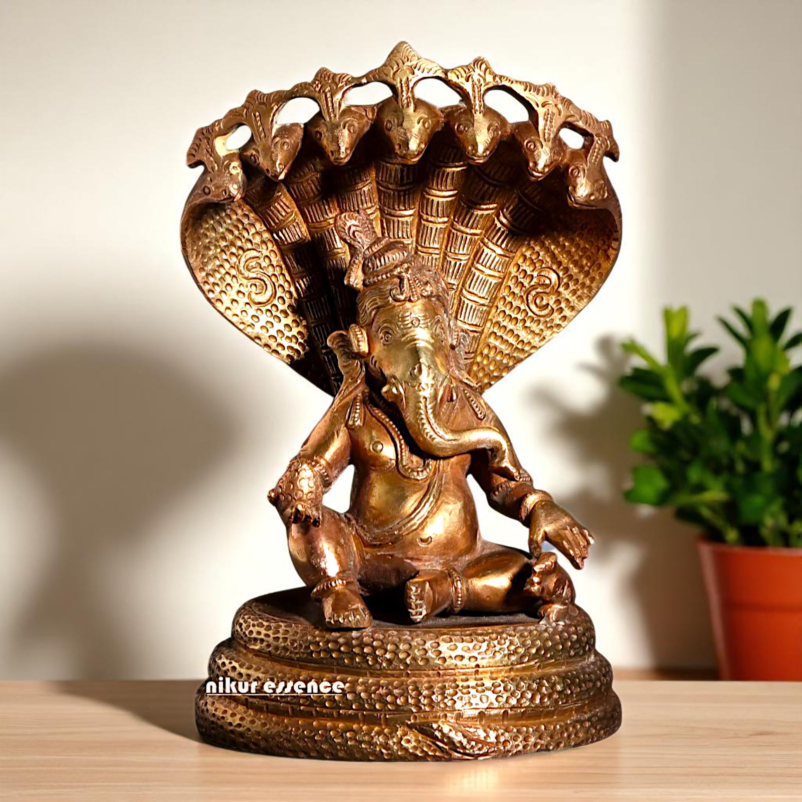 Bronze/Panchaloha Ganesha seated on sheshnag statue - 7 Inches Nikuressence
