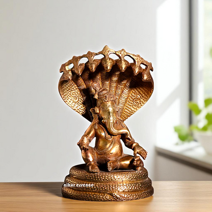 Bronze/Panchaloha Ganesha seated on sheshnag statue - 7 Inches Nikuressence