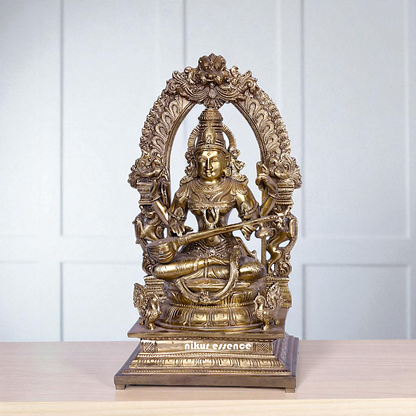 Goddess Saraswati Devi Seated on kirtimukha throne with Playing Veena Bronze/Panchaloha idol - 16 Inches Nikuressence