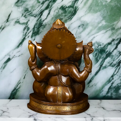 Ganesh Blessing seated with Four Armed Brass idol - 14 Inches Nikuressence