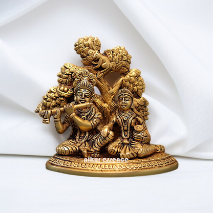 Radha krishna with Tree seated and Playing Flute Brass idol - 5.5 Inches Nikuressence