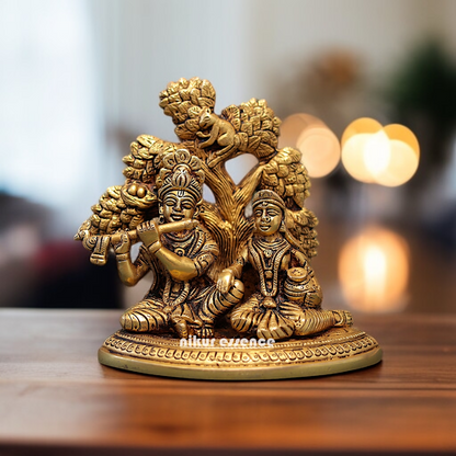 Radha krishna with Tree seated and Playing Flute Brass idol - 5.5 Inches Nikuressence