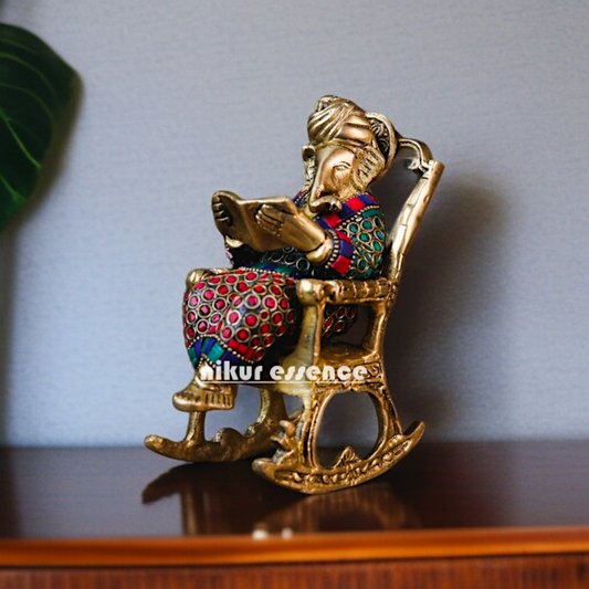 Ganesha Read Book Seated on swing chair Brass with stone work idol - 7 Inches Nikuressence