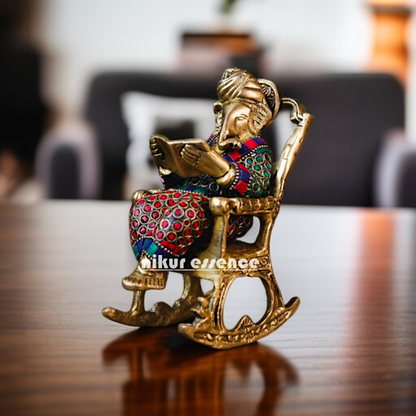 Ganesha Read Book Seated on swing chair Brass with stone work idol - 7 Inches Nikuressence